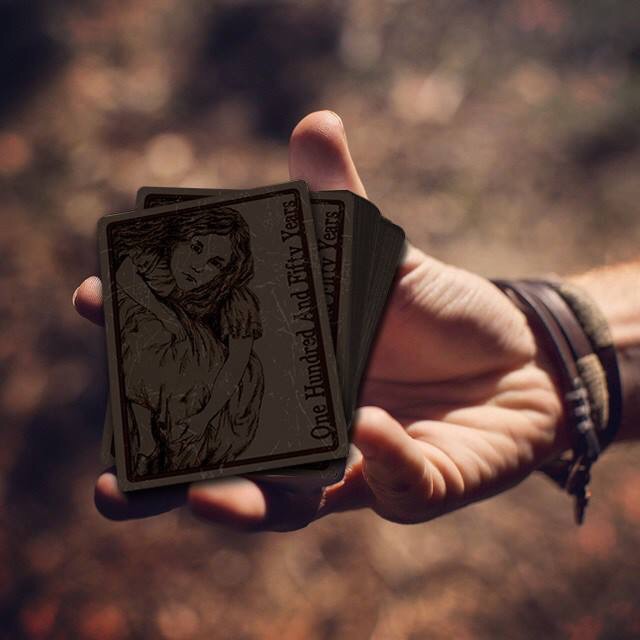 hand holding deck of Alice cards